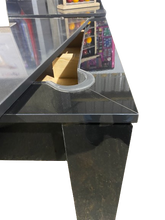 Load image into Gallery viewer, Close-up of the Rosetta pool dining table's pocket and gloss black finish.