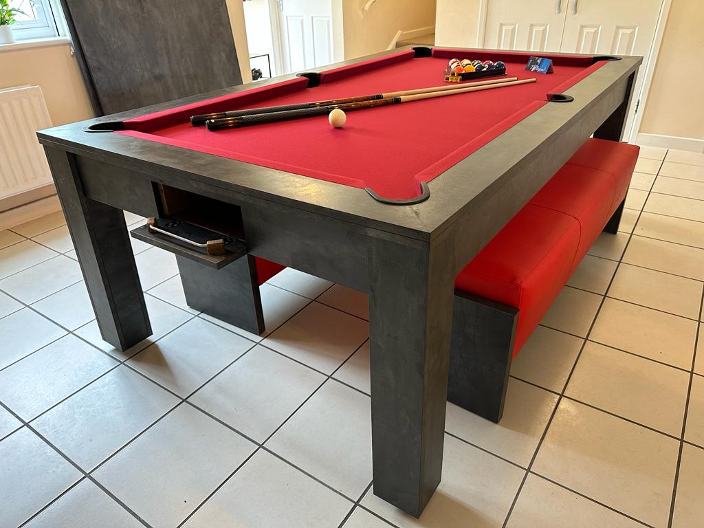 Side view of pool dining table with red felt and built-in accessory drawer.
