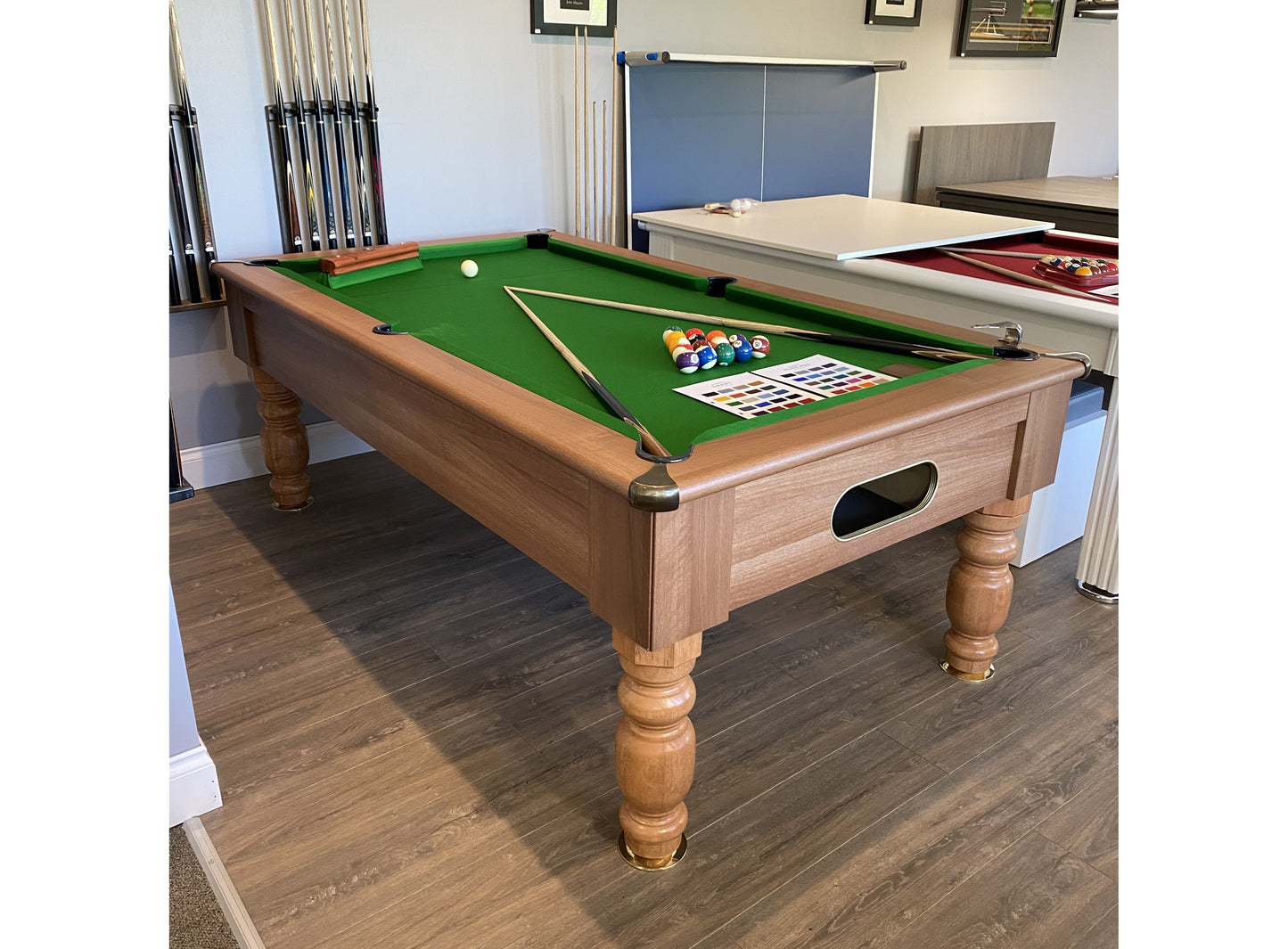 Optima Rennes walnut finish pool table displayed in a showroom setting.