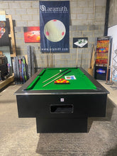 Load image into Gallery viewer, Superpool Black Pearl pool table with green felt and accessories in a showroom.