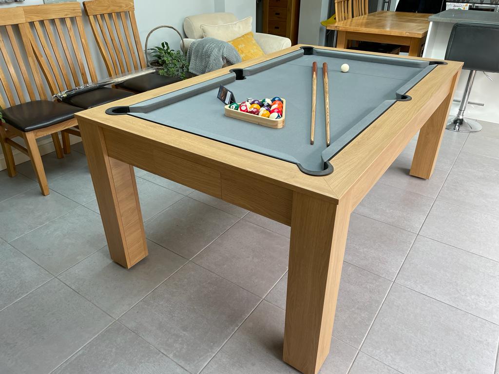 Nebraska Oak Rosetta pool dining table with gray felt and pool accessories.