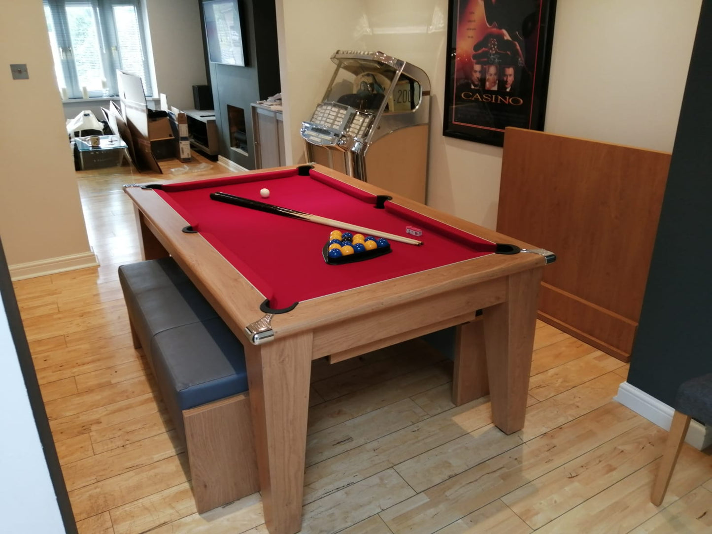 Supreme Oak Classic Diner pool table with red felt and bench seating in a cozy room.