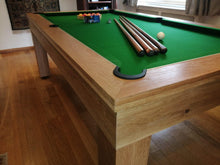 Load image into Gallery viewer, Close-up of oak pool table with green felt and corner detail.