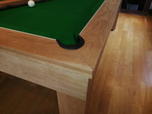 Load image into Gallery viewer, Close-up of oak pool table corner with green felt.