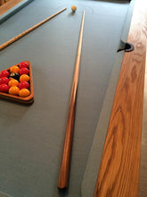 Load image into Gallery viewer, Close-up of oak pool table with blue felt and pool cues.