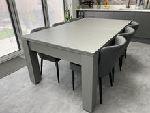 Load image into Gallery viewer, Satin Grey Rosetta pool dining table set up as a dining table with chairs.