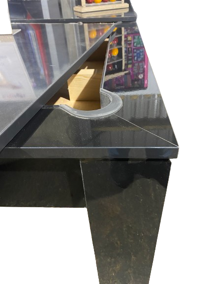 Close-up of the Rosetta pool dining table's pocket and gloss black finish.