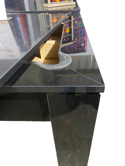 Close-up of the Rosetta pool dining table's pocket and gloss black finish.