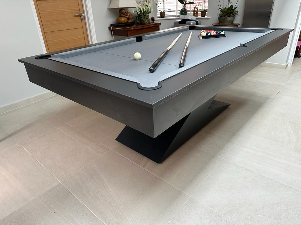 Angled view of the matt black LIGHTNING pool diner table with minimalist design.