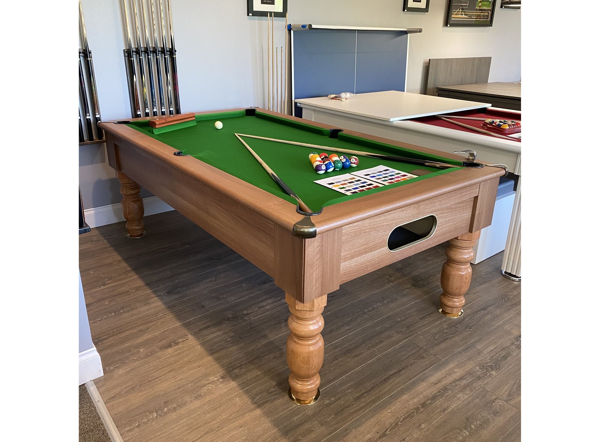 Optima Rennes walnut finish pool table displayed in a showroom setting.