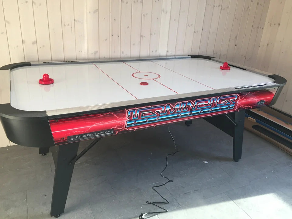 Buffalo Terminator Air Hockey table displayed in a wooden games room.