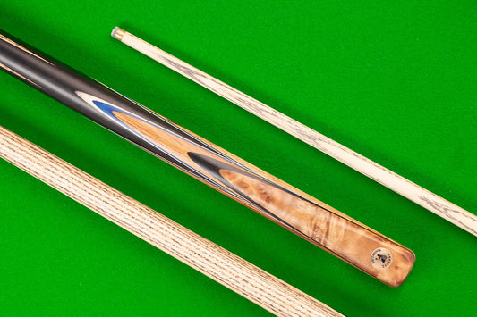 Trident Britannia 8 Ball Pro Cue with intricate wood grain design on green felt.