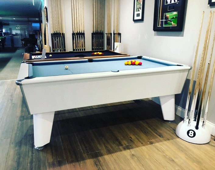 White Optima Classic slate bed pool table in a stylish game room setting.