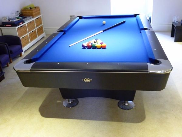 Buffalo Dominator 8' American pool table with blue felt and chrome accents.