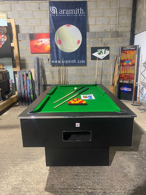 Superpool Black Pearl pool table with green felt and accessories in a showroom.
