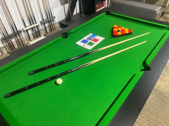 Superpool Black Pearl pool table with green felt and match play accessories.