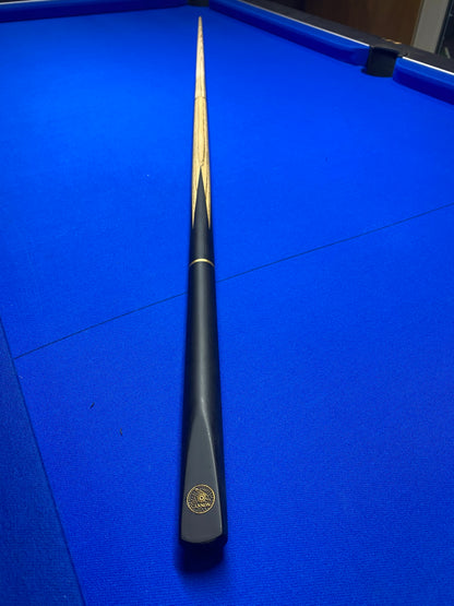 Fully assembled Cannon Manta 3 Piece 57-inch cue on a blue pool table.
