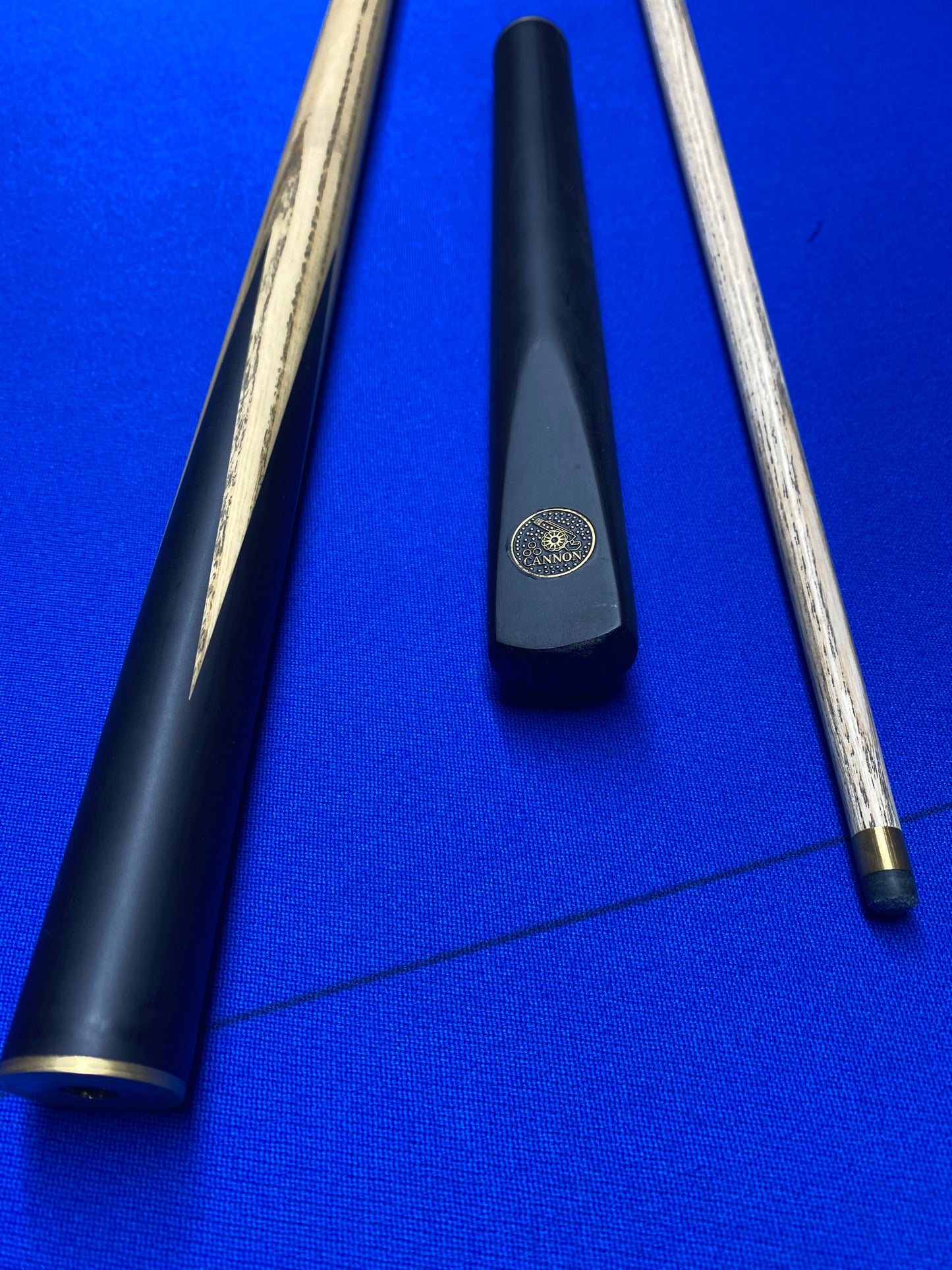 Cannon Manta 3 Piece 57-inch cue parts laid out on a blue surface.