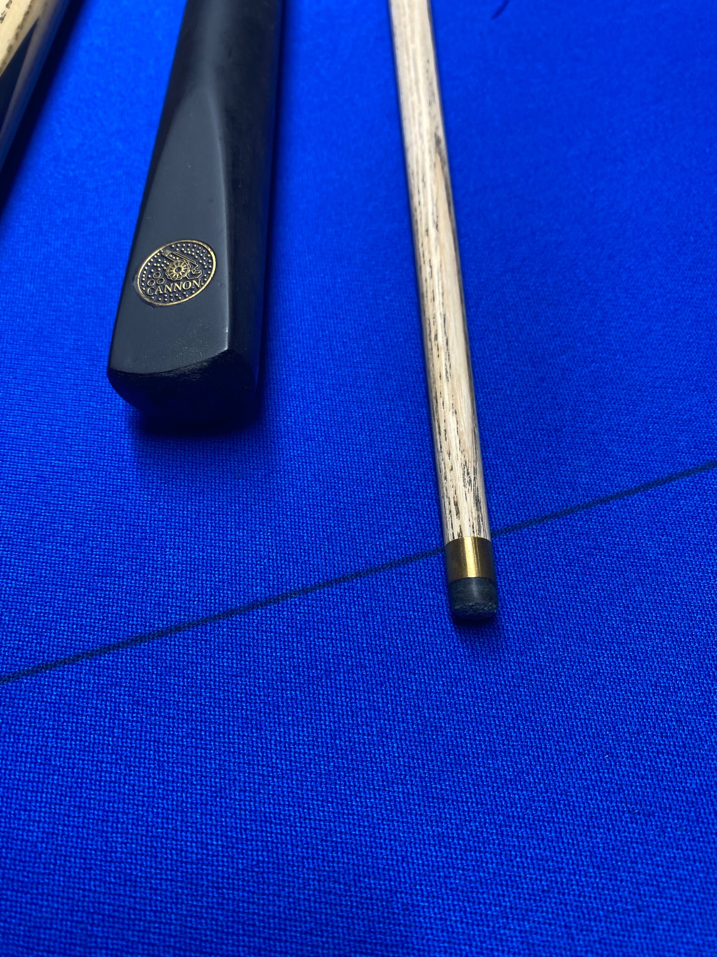 Detailed view of Cannon Manta cue tip and handle with brass ferrule.