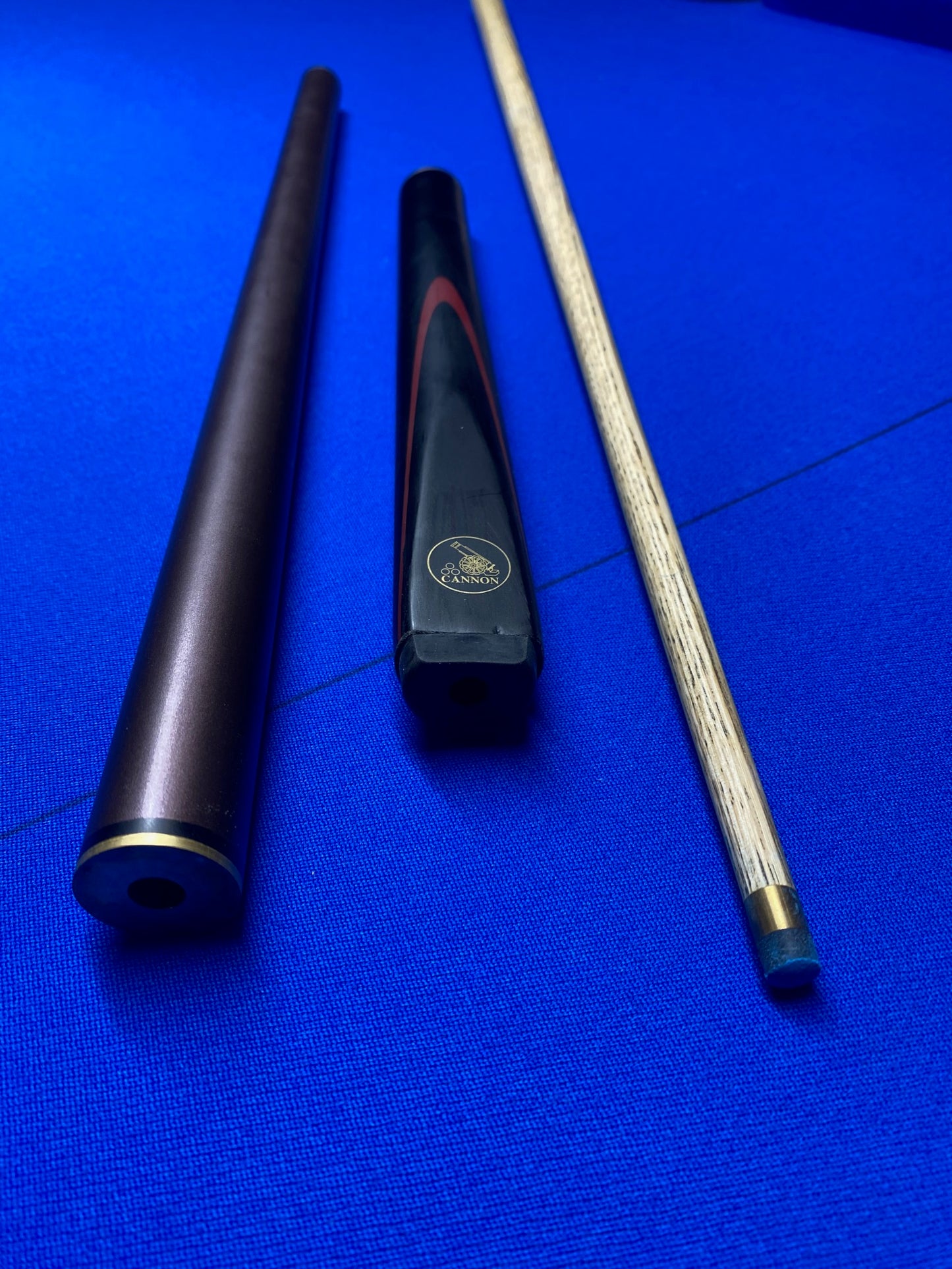 Cannon Viper 3 Piece 57-inch cue parts laid out on blue surface.
