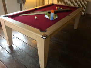 Supreme Oak Classic Diner pool table with red felt in a rustic room.