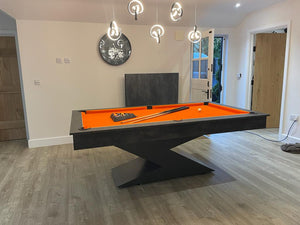 Monaco Grey Lightning pool diner table with orange felt in a contemporary room.