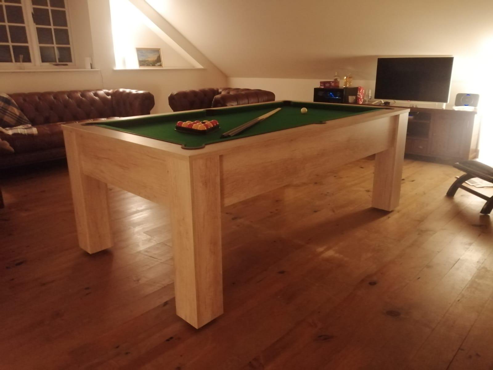 Nebraska Oak pool table with green felt in a warm, rustic living space.