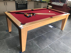 Supreme Oak Classic Diner pool table with red felt and accessories in a kitchen.