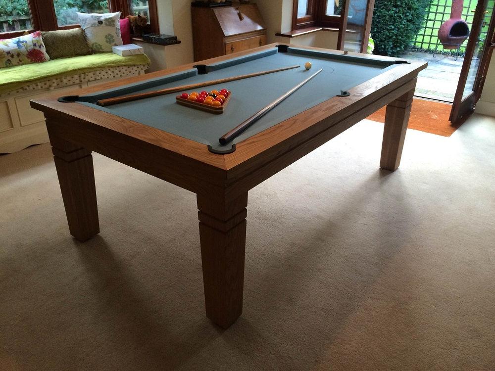 Oak pool table with blue felt in a cozy living space.
