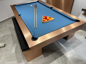 Modern brushed copper pool diner table featuring a blue felt top and cues.
