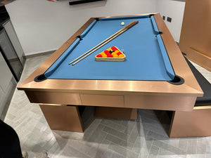 Custom brushed copper pool table with blue felt and integrated storage.