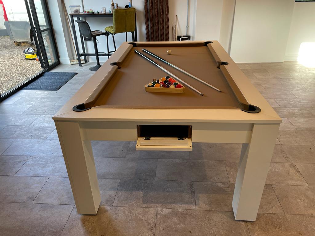 Satin white Rosetta pool dining table with tan felt and pool cues.