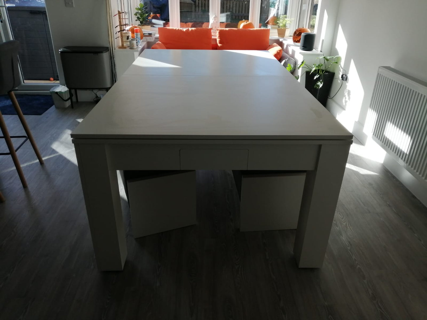Satin white Rosetta dining table with a sleek design in a bright room.