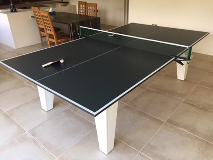 7' x 4' table tennis top on a dining table with net and paddle.