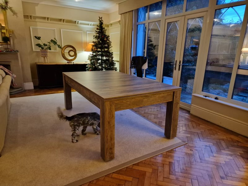 Santa Fe Walnut Rosetta dining table setup in a stylish room with a dog nearby.