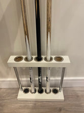 Load image into Gallery viewer, White Superpool Match Cue Stand placed against a wall, holding 5 cues.