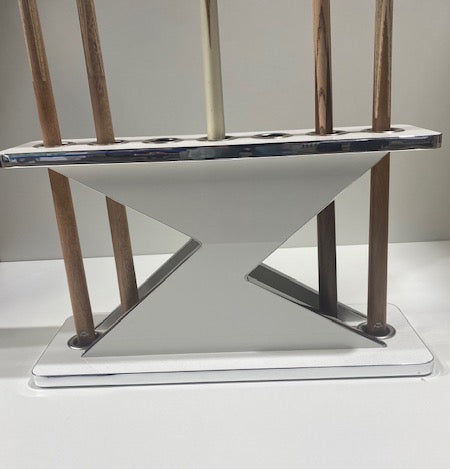 White and chrome Lightning Cue Stand by Superpool holding wooden cues.