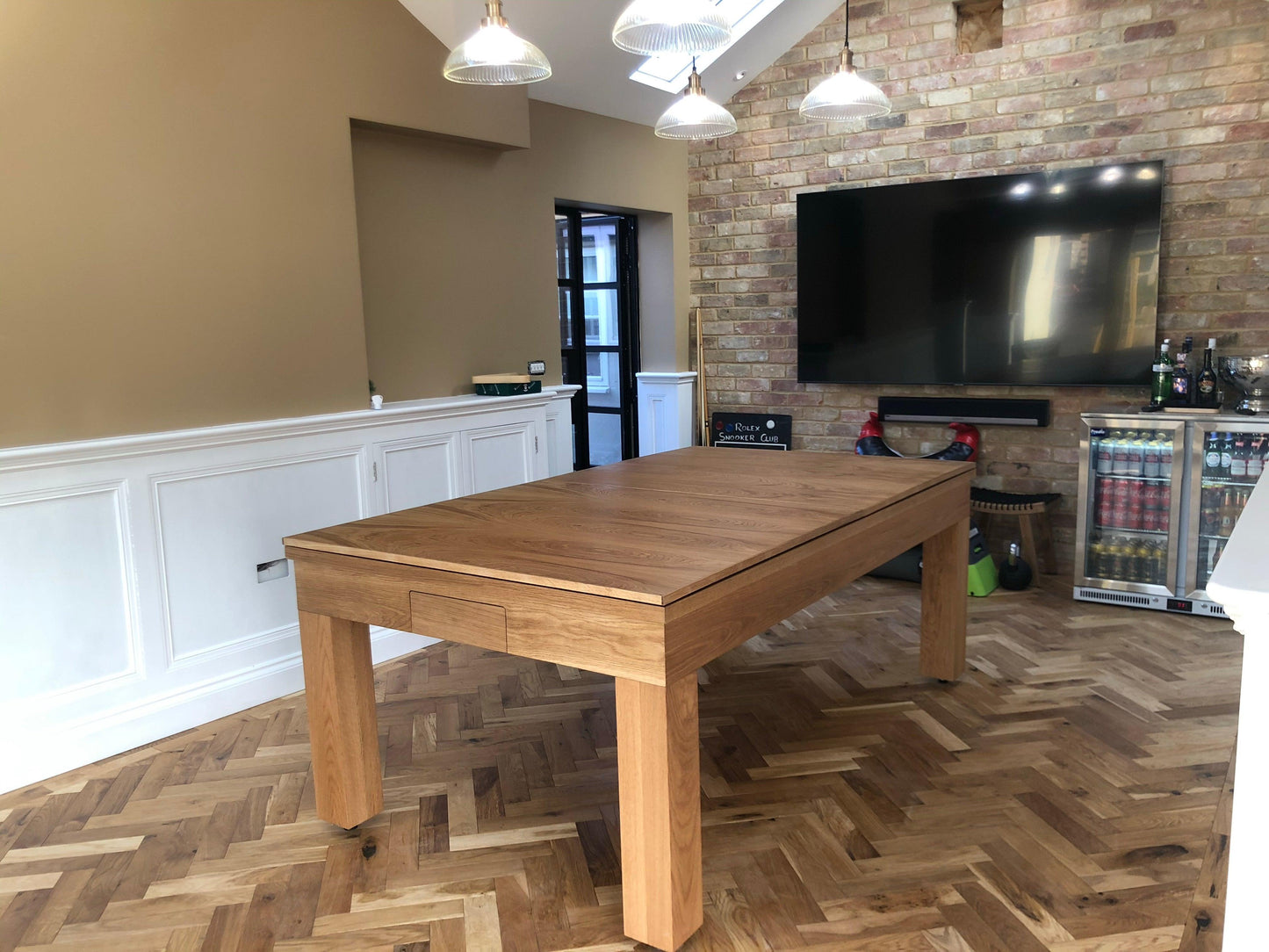 Natural oak dining table in a modern living room setting.